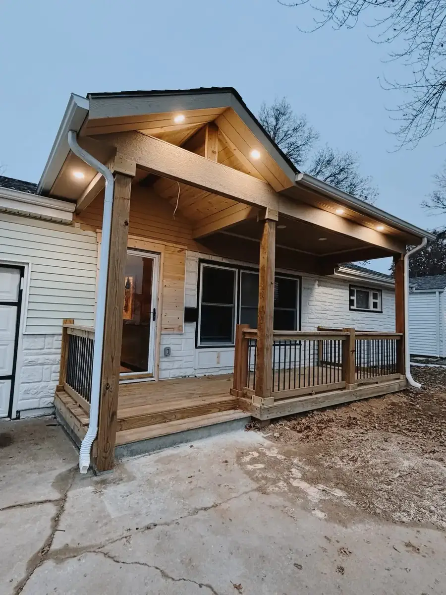 Custom wooden covered front porch with gable roof — outdoor living build in Smithville MO